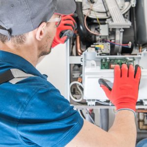 man inspecting furnace